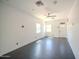 Spacious room with black floors, two windows, and a door with a Harley sign above it at 10105 E Cactus Rd, Scottsdale, AZ 85260