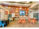 Resident activity center featuring games, seating areas, vending machines, and playful decor at 10156 E Radiant Ave, Mesa, AZ 85212