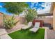 Relaxing backyard featuring lounge chairs, desert plants, gravel, and artificial grass at 10156 E Radiant Ave, Mesa, AZ 85212