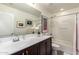 Well-lit bathroom with white countertops, a dark wood vanity, and a shower-tub combination at 10156 E Radiant Ave, Mesa, AZ 85212