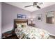 Bedroom with a vibrant bedspread, colorful pillows, and a window offering natural light at 10156 E Radiant Ave, Mesa, AZ 85212