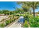 Beautifully landscaped common area with walking paths and seating at 10156 E Radiant Ave, Mesa, AZ 85212