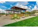 Relaxing community seating area with comfortable green chairs and serene landscaping at 10156 E Radiant Ave, Mesa, AZ 85212