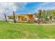 Unique community architectural feature surrounded by green grass and mature trees at 10156 E Radiant Ave, Mesa, AZ 85212
