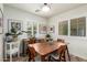 Bright dining area featuring a wooden table set, white shutters, and a built-in desk for a flexible space at 10156 E Radiant Ave, Mesa, AZ 85212