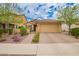 Charming single level home with a well-manicured front yard and brick paved driveway at 10156 E Radiant Ave, Mesa, AZ 85212