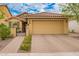 Inviting single level home with a paver driveway, decorative stone accents, and gated courtyard entry at 10156 E Radiant Ave, Mesa, AZ 85212