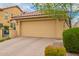 Charming home featuring a two-car garage, paver driveway, and desert landscaping at 10156 E Radiant Ave, Mesa, AZ 85212