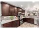 Updated kitchen features stainless steel appliances, modern cabinets, tile backsplash, and neutral countertop at 10156 E Radiant Ave, Mesa, AZ 85212