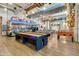 Spacious rec room with ping pong table, shuffle board, pool table and playful decor at 10156 E Radiant Ave, Mesa, AZ 85212
