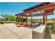 Inviting community park featuring a shaded pergola with seating and manicured landscaping at 10156 E Radiant Ave, Mesa, AZ 85212