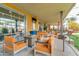 Outdoor lounge with comfortable seating, a fire pit, and views of the green space at 10156 E Radiant Ave, Mesa, AZ 85212