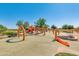 Modern community playground showcasing climbing structures and multiple slides for  at 10156 E Radiant Ave, Mesa, AZ 85212