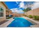 Beautiful backyard featuring a sparkling pool, desert landscaping, and a serene outdoor living space at 10156 E Radiant Ave, Mesa, AZ 85212