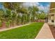 Well-maintained backyard with lush greenery and a sidewalk, perfect for relaxation and recreation at 102 W Almeria Rd, Phoenix, AZ 85003