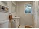 Bathroom featuring a pedestal sink, modern fixtures, a window for natural light, and a decorative shower curtain at 102 W Almeria Rd, Phoenix, AZ 85003
