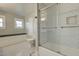 Bright bathroom with a sleek glass shower, white tile, and ample natural light at 102 W Almeria Rd, Phoenix, AZ 85003