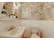 Charming half bathroom with decorative wallpaper, pedestal sink, and traditional fixtures at 102 W Almeria Rd, Phoenix, AZ 85003