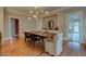 Formal dining room with hardwood floors, elegant chandelier, and views into other rooms at 102 W Almeria Rd, Phoenix, AZ 85003