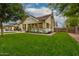 Beautiful front exterior of craftsman style home with large green lawn and mature shade trees at 102 W Almeria Rd, Phoenix, AZ 85003