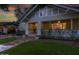 Charming front exterior of craftsman style home with covered porch, green lawn, and lush landscaping at 102 W Almeria Rd, Phoenix, AZ 85003