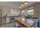 Modern kitchen featuring stainless steel appliances, a large island, and stylish lighting fixtures at 102 W Almeria Rd, Phoenix, AZ 85003