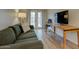 Inviting living room featuring a work space, comfortable seating, French doors, and modern lighting at 102 W Almeria Rd, Phoenix, AZ 85003