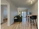 Open living room with wood-look floors, a comfortable couch, and access to an outdoor area through double doors at 102 W Almeria Rd, Phoenix, AZ 85003