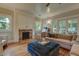 Living room featuring a brick fireplace, windows, hardwood flooring, and comfortable seating at 102 W Almeria Rd, Phoenix, AZ 85003
