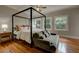 Serene main bedroom with ample natural light, a four-poster bed, and a comfortable sitting area at 102 W Almeria Rd, Phoenix, AZ 85003