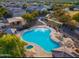 Aerial view showcases a community pool, spa, playground, green spaces, and walking paths in a neighborhood at 1059 S Cheshire Ln, Gilbert, AZ 85296