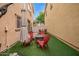 Inviting backyard with artificial turf, a firepit, and red patio furniture at 1059 S Cheshire Ln, Gilbert, AZ 85296