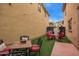 The backyard has outdoor seating, artificial turf and a fire pit table at 1059 S Cheshire Ln, Gilbert, AZ 85296