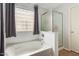Well-lit bathroom featuring a soaking tub and glass enclosed shower at 1059 S Cheshire Ln, Gilbert, AZ 85296