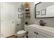 Bright bathroom features a white vanity with dark fixtures, decor and art at 1059 S Cheshire Ln, Gilbert, AZ 85296