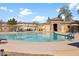 Inviting community pool with lounge chairs and shade canopies in a well-maintained area at 1059 S Cheshire Ln, Gilbert, AZ 85296