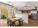 Cozy dining area adjacent to kitchen with rustic table and modern lighting at 1059 S Cheshire Ln, Gilbert, AZ 85296