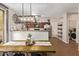 Stylish dining area with farmhouse table, leading to kitchen with stainless appliances at 1059 S Cheshire Ln, Gilbert, AZ 85296