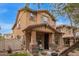 Inviting two-story home with landscaped yard and cozy front porch with rocking chairs at 1059 S Cheshire Ln, Gilbert, AZ 85296