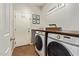 Bright laundry room with modern washer and dryer and lots of storage at 1059 S Cheshire Ln, Gilbert, AZ 85296
