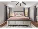 Spacious bedroom featuring a plush bed, area rug and a ceiling fan at 1059 S Cheshire Ln, Gilbert, AZ 85296