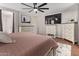 Bedroom featuring a plush bed, hardwood floors, a ceiling fan and TV at 1059 S Cheshire Ln, Gilbert, AZ 85296