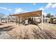 Shaded community playground featuring slides, climbing structures, and a sand play area at 1059 S Cheshire Ln, Gilbert, AZ 85296