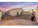 Charming backyard featuring desert landscaping, string lights and patio space at 10772 W Woodland Ave, Avondale, AZ 85323