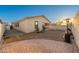 Cozy backyard featuring brick patio, string lights, stucco walls, and heater for outdoor entertaining at 10772 W Woodland Ave, Avondale, AZ 85323