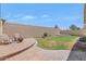 Private backyard featuring a brick patio, a grassy area, and a block wall for privacy at 10772 W Woodland Ave, Avondale, AZ 85323