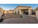 Backyard with string lights, paver patio, and block wall surround at 10772 W Woodland Ave, Avondale, AZ 85323