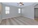 Spacious bedroom featuring carpeted floors, neutral paint, ceiling fan and two windows at 10772 W Woodland Ave, Avondale, AZ 85323