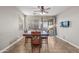This dining room features a wood table with seating, tile flooring, and natural light from the sliding doors at 10772 W Woodland Ave, Avondale, AZ 85323