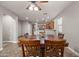 Well-lit dining room with wood table and chairs, with an open view to the kitchen at 10772 W Woodland Ave, Avondale, AZ 85323